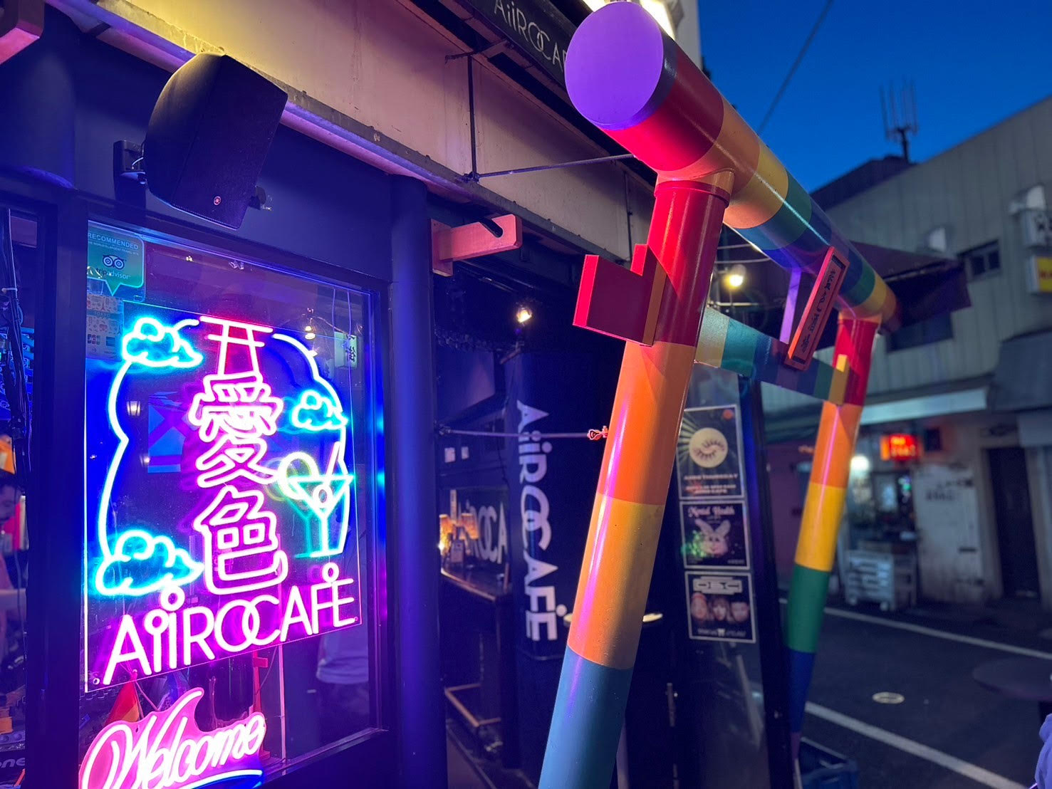 Close view of AiiRO CAFE's rainbow torii and neon entrance sign